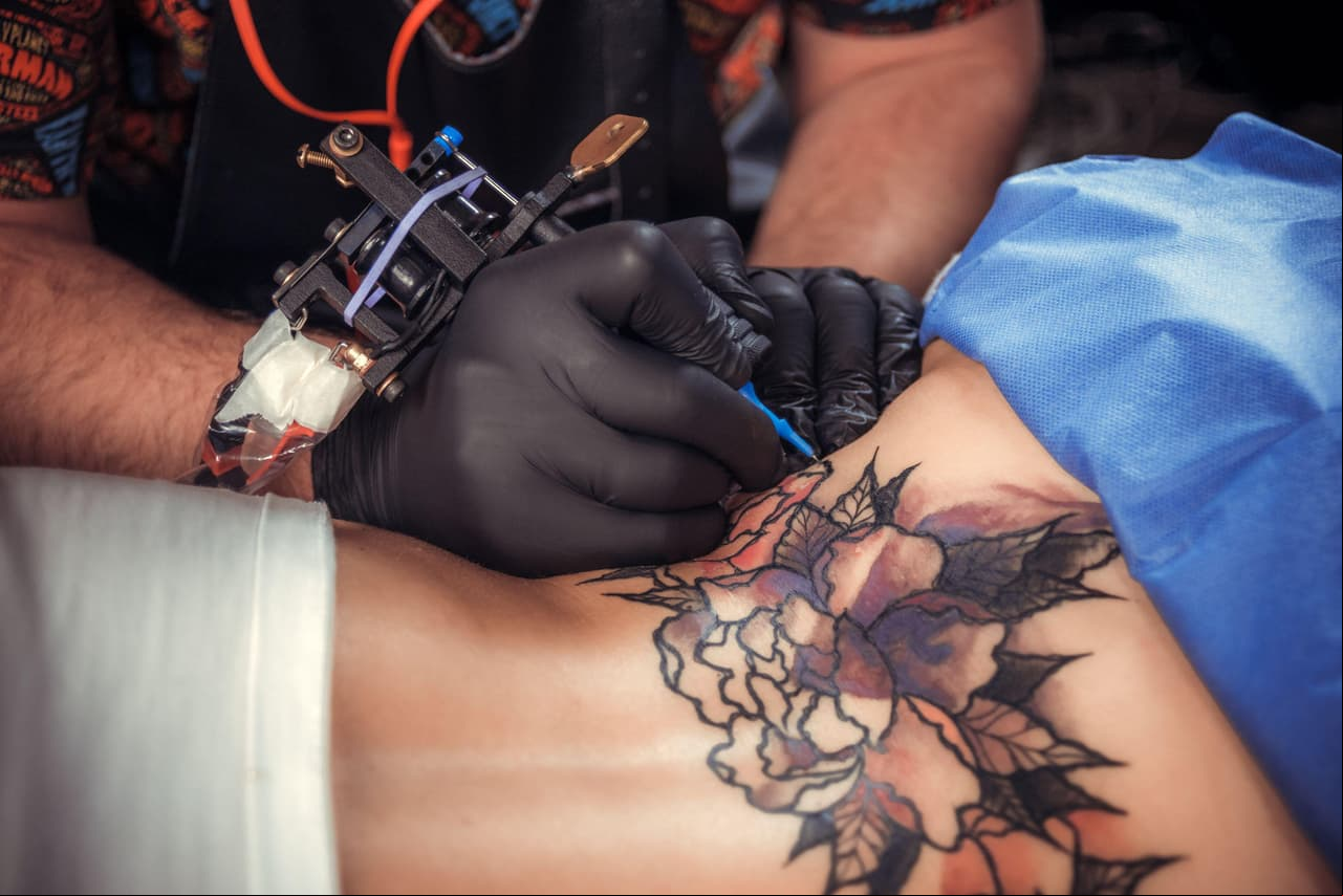 Tattooer at work in salon