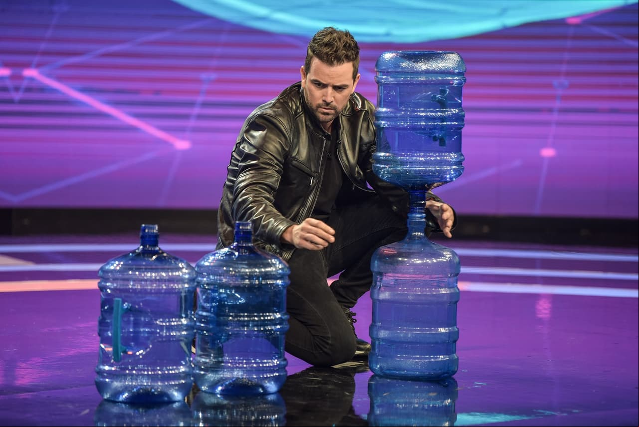 Mane de la Parra se enfrentó al reto ‘Armando Torres’, que consistió en acomodar cuatro garrafones de agua vacíos hasta lograr crear una torre equilibrada sin que se derrumbara.